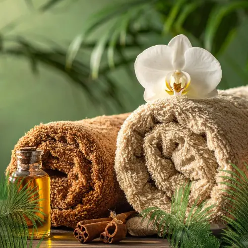 Serviettes chaudes et huile de massage illustrant le toucher sacré du Massage Énergétique Pineabayah